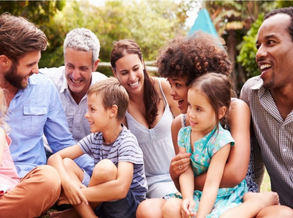 Several happy families having a good time outdoors